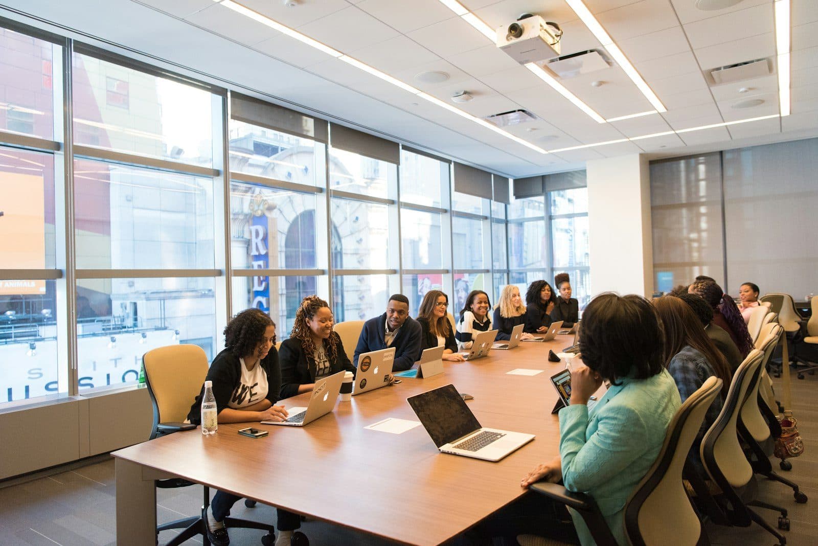 Client workshop in a bright boardroom with laptops around the table